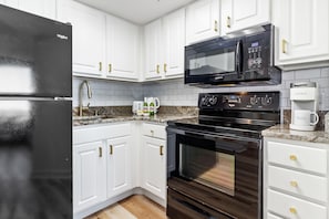 Culinary inspiration starts in the fully equipped kitchen of our chic suite!