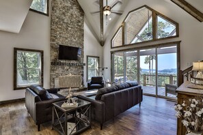 Main living room looking to fireplace and outdoor covered deck