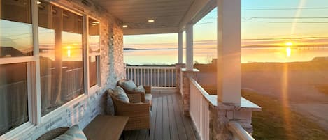 Relaxing porch furniture invites you to unwind in the midst of natures spectacle
