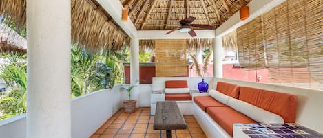 Private palapa area with ocean view, living area and dining area and area for food preparation .