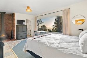 Room 5 has a panoramic ocean view window, king bed, and classic Malm fireplace.