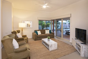 Lounge room with TV, connects to outdoor patio area.