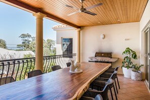 Just off the kitchen, the balcony is furnished with a large dining table and BBQ.