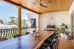 Just off the kitchen, the balcony is furnished with a large dining table and BBQ.