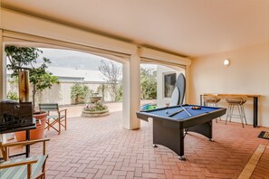 Challenge friends to a game of pool or shuffleboard in this spacious indoor-outdoor area.