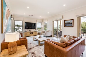 The bright and airy upstairs lounge is a comfortable space to unwind, with contemporary décor and access to the balcony.