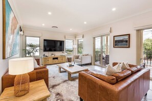 The bright and airy upstairs lounge is a comfortable space to unwind, with contemporary décor and access to the balcony.