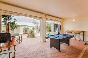 Challenge friends to a game of pool or shuffleboard in this spacious indoor-outdoor area.