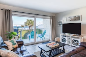 The cozy living room features a large tv for streaming movies and spectacular ocean views.