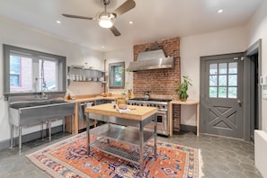 Industrial-style kitchen with an oversized range and sink.