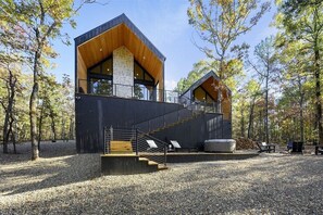 Exterior Retreat: Nestled in nature, enjoy stunning views and a private hot tub among the trees!