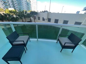 Seating for two with the palm trees swaying the in background on our patio