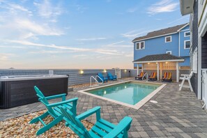 The private pool provides seating both in the sun and shade, along with stunning waterfront views.