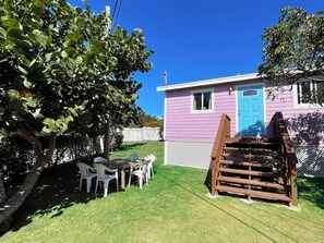 Exterior view. We added the outdoor chairs and table under the Sea Grape tree.