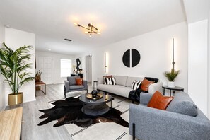Living room with ample seating and modern lighting