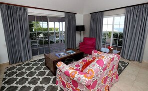 Relax on the sofa or step out onto your private furnished patio or balcony to enjoy the lovely garden view.