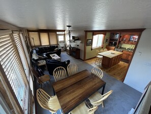 Spacious living area with door accessing hot tub deck.