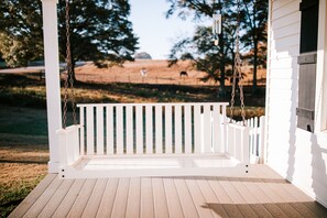 Classic Southern Porch, complete with all the sights and sounds of the farm.