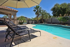 Shade and plenty of area to play and enjoy this large swimming pool. 