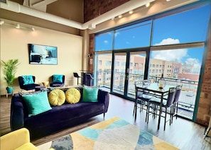 Open concept living space with massive windows and balcony doors let in an abundance of natural light. The feel is expansive and inviting.