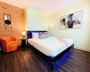 The master bedroom is a stylish blend of comfort and character, featuring a beautiful exposed brick wall that adds warmth and charm to the space.
