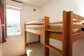 The cozy sleeping alcove features a bunk bed.