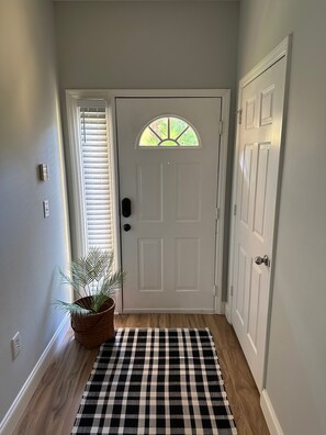 Foyer with laundry room on right.  Washer and Dryer provided.