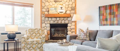 Living room with big comfy sectional and gas fireplace.