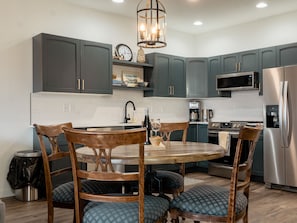 Eat in kitchen fully stocked with appliances and cookware.