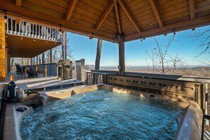 Relax in the oversized hot tub while you take in the views
