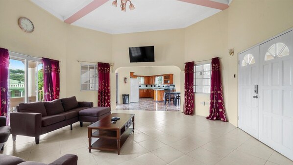 Living room with view of kitchen in background