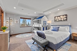 Experience the epitome of family-friendly luxury in our 2ndfloor bedroom. Enjoy the spacious comfort of a queen bed while the kids delight in their playful bunkbeds. With a walk-in closet for added convenience and an ensuite bathroom.