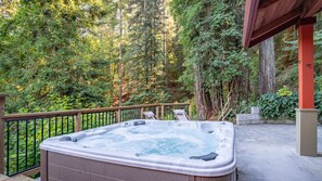 Enjoy nature's serenity and relax in our hot tub with stunning forest views.