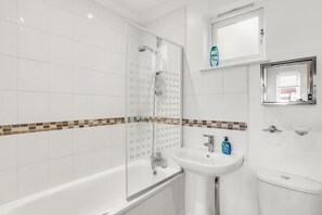 Seamless and well-lighted bathroom for a relaxing dip.