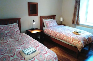 2 single beds with full wardrobe, bedside tables and lamps.