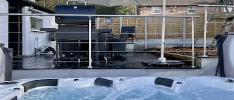 Large Jacuzzi with a barbecue patio. 