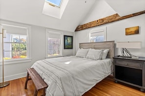 Bedroom #2 with queen bed, vaulted ceilings, flatscreen smart Roku TV, and closet.