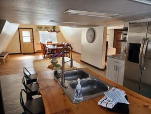 Kitchen is attached to dining room with door to outside.