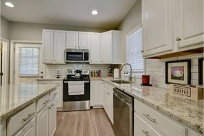 Large and highly functional galley kitchen with ‘eat-on’ island seating 6.