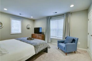 King bed primary bedroom with Smart TV and large closet space. 