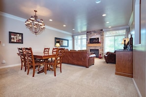 Experience the cozy living room, outfitted with plush seating, an expansive smart TV, and patio doors that frame the breathtaking mountain vistas.