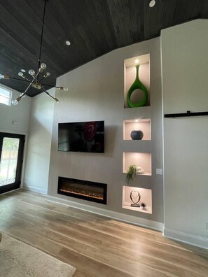 Watch cable or your favorite streaming channels on our big screen TV and enjoy our electric fireplace.