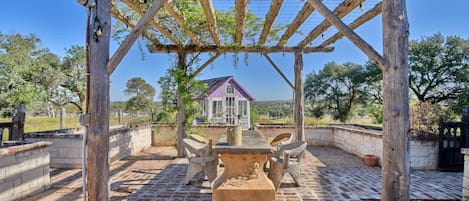 Dine al fresco under the lit trellis along with propane grill.