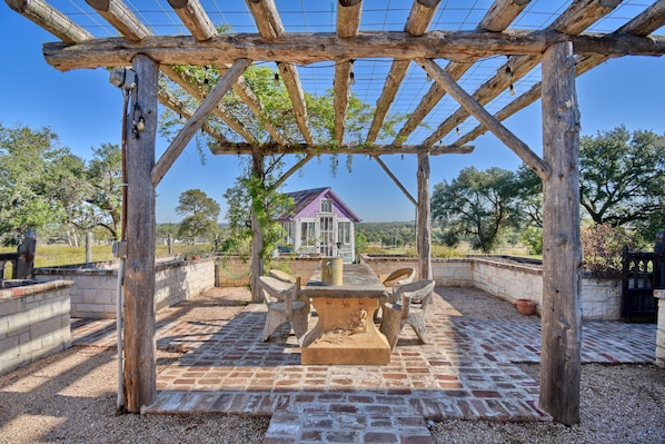 Dine al fresco under the lit trellis along with propane grill.