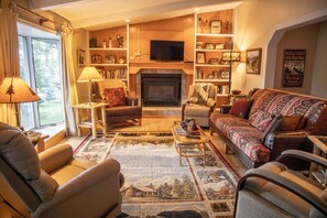 Warm and inviting living room with cable TV, a fireplace, and Montana decor
