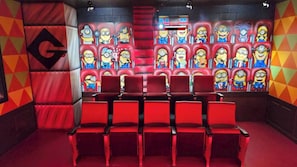 Movie theater with 12 seats and stage. Ample room for sleeping bags or floor seating.