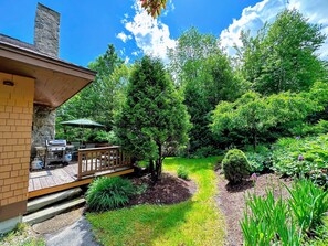 A lovely garden area surrounds the deck