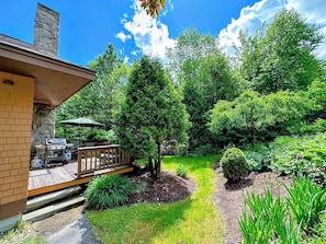A lovely garden area surrounds the deck