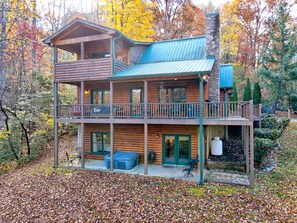 View of the back of house showing all decks and the hot tub :)