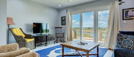 Indulge in comfort and elegance within the living room of this delightful townhouse - your perfect retreat near the beach.